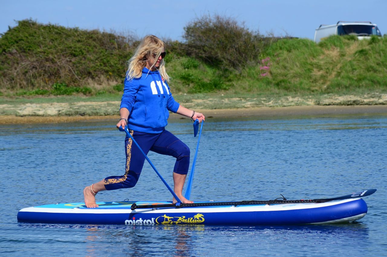 girl on a paddleboard doing resistance training